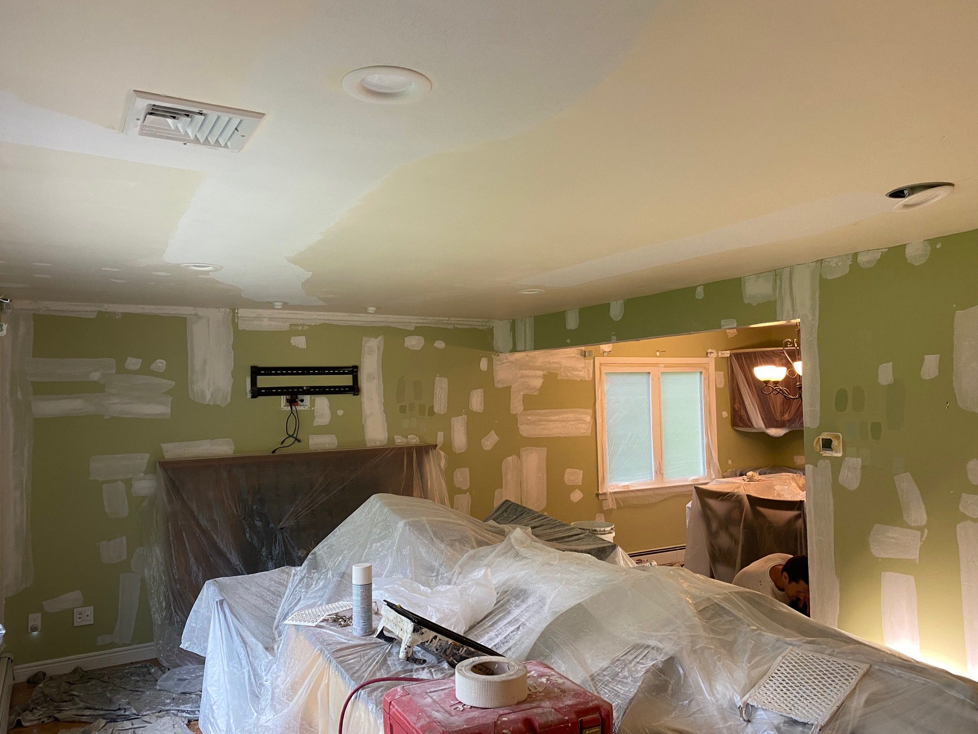 Room under renovation with covered furniture