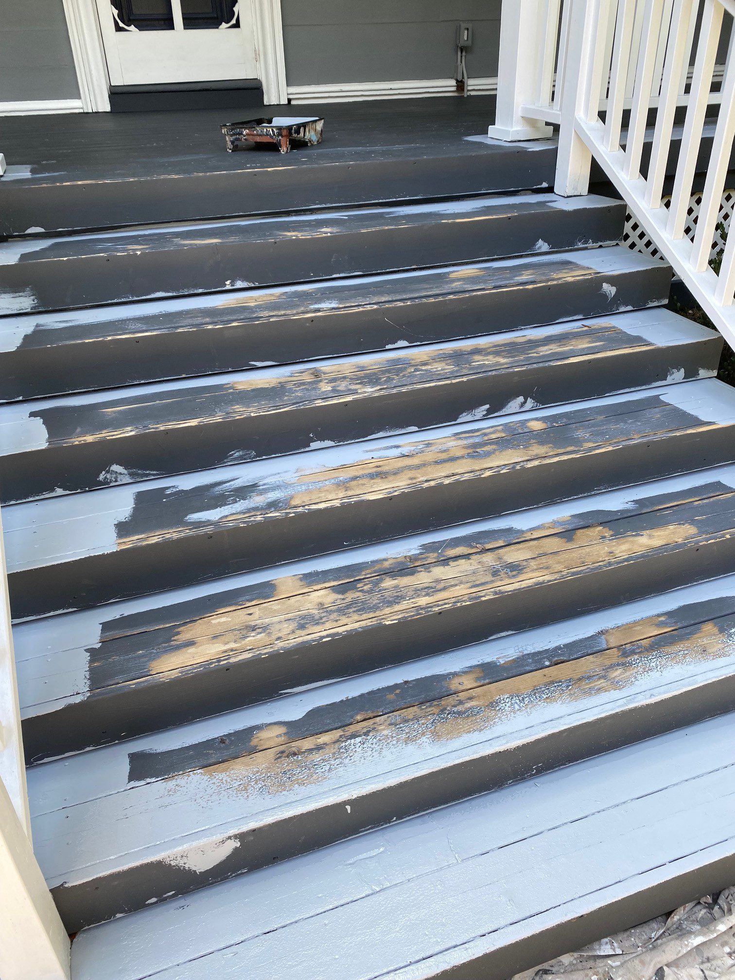 Front porch stairs partially stripped and painted