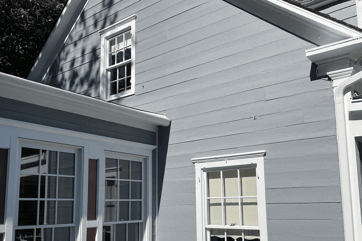 Gray house exterior with white-trim windows