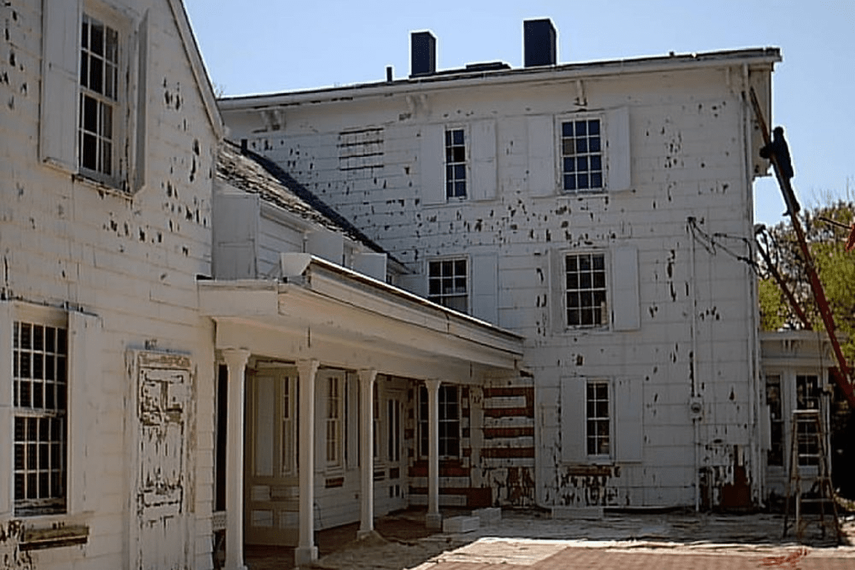 Abandoned white building with peeling paint