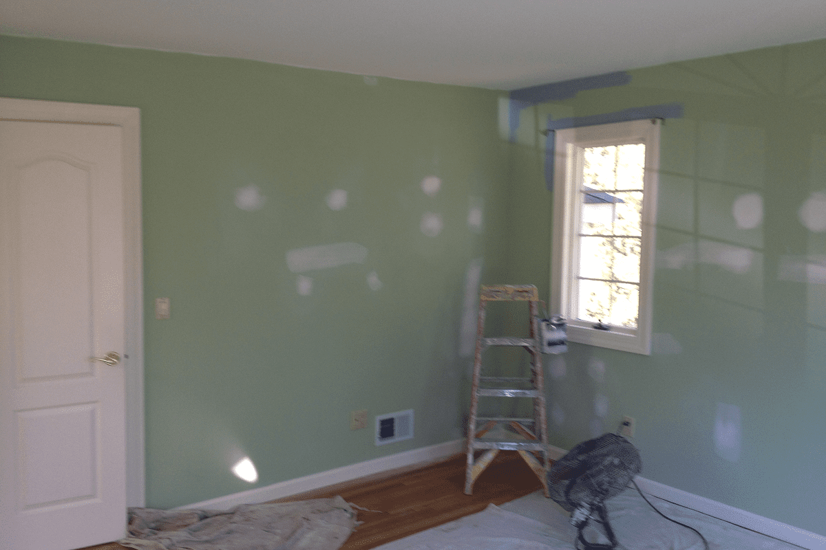 Green bedroom renovation with ladder and patches