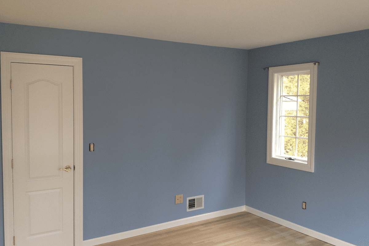 Empty room with blue walls, door and window