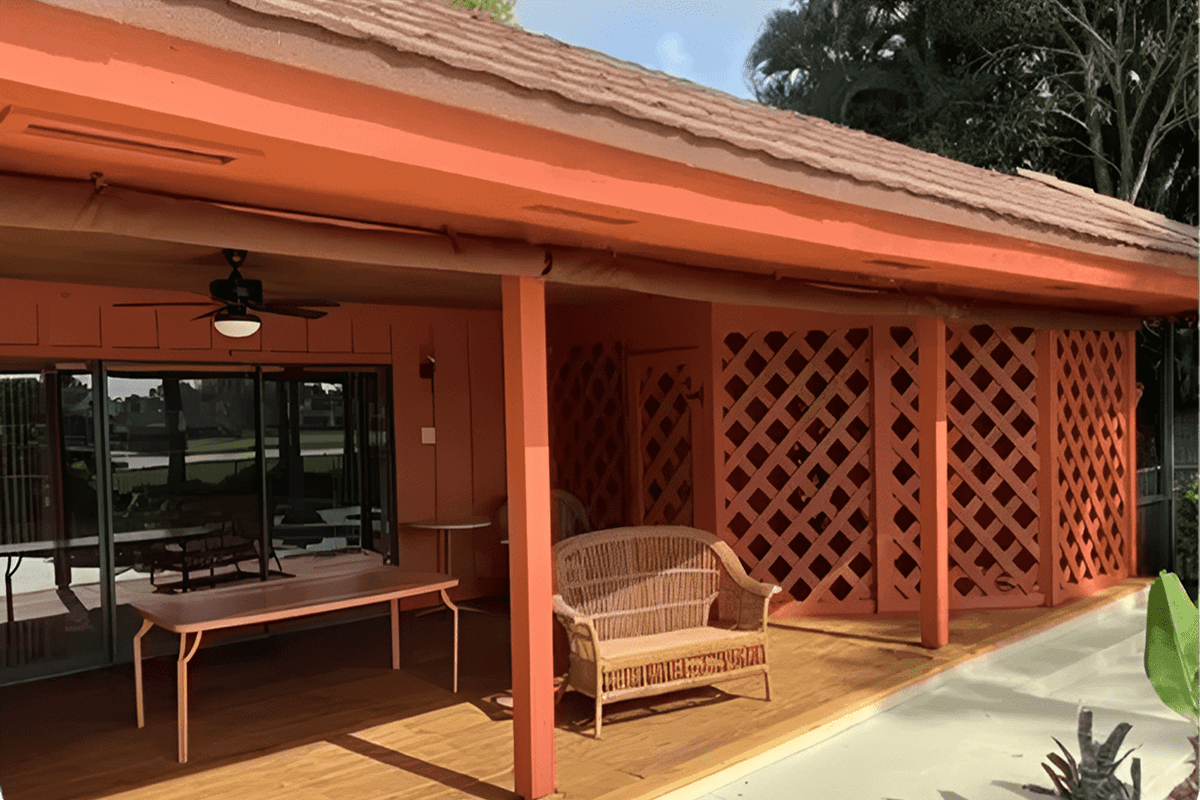 Orange patio with wicker loveseat and lattice